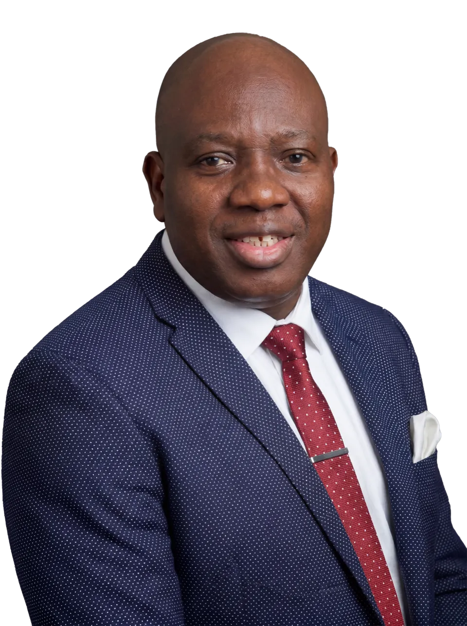 Lead Pastor David Adeosun of Kingdom Stars Assembly Guelph smiling in a navy polka dot blazer and red tie, studio portrait