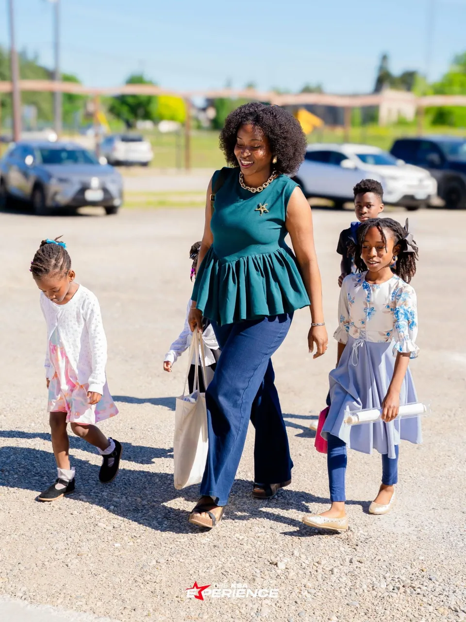 A mother walking with her children across the parking lot, arriving for a service at Kingdom Stars Assembly in Guelph