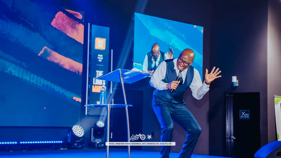 Pastor David Adeosun preaching on the stage at Kingdom Stars Assembly